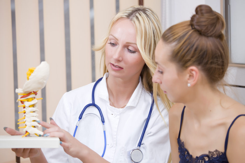 doctor talking to a patient and helping patient understand illness.